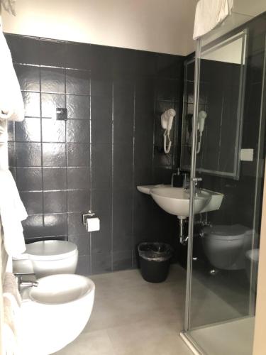 a bathroom with a toilet and a sink and a shower at Villa Regina in Riva del Garda