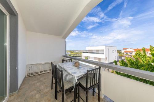 a balcony with a table and chairs with a view at Perinic, No 1 in Vrsi