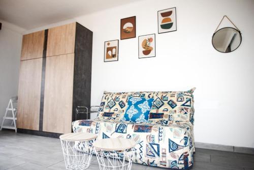 a living room with a couch and two tables at Studio Seghier in Prats-de-Mollo-la-Preste