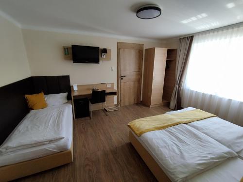 a bedroom with a bed and a desk and a television at Pokoje u Krysi in Rzymkowice