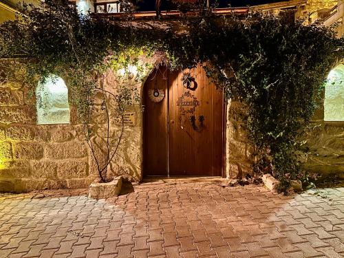 an entrance to a stone building with a wooden door at Zanta Suite Hotel in Urgup