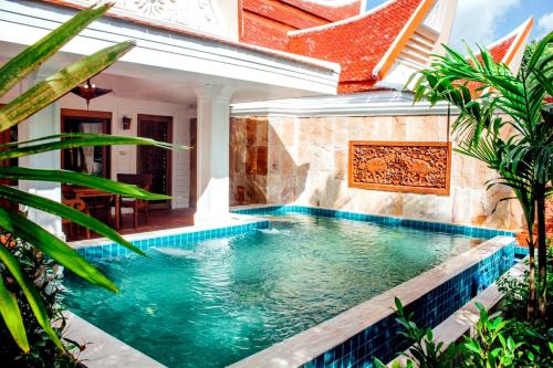a swimming pool in the backyard of a house at Santhiya Koh Chang Resort in Ko Chang