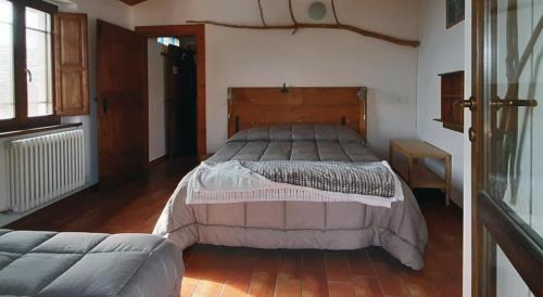 a bedroom with a large bed and a couch at Country House Ca' Vernaccia in Urbino