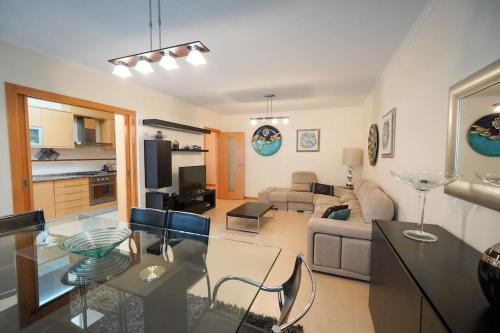a living room with a couch and a table at Dalila's house - Spacious and Comfortable 3-Bedroom Apartment with Garage in Nazaré
