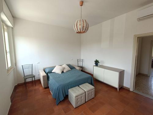a bedroom with a bed and a table and a chair at A due passi dai Miracoli in Pisa