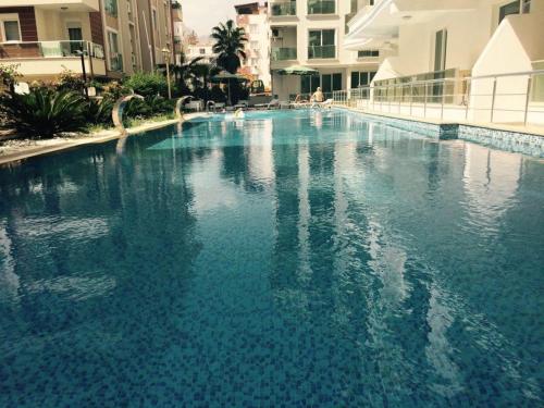 a large pool of blue water in a building at AQUA CİTY SUİT in Antalya