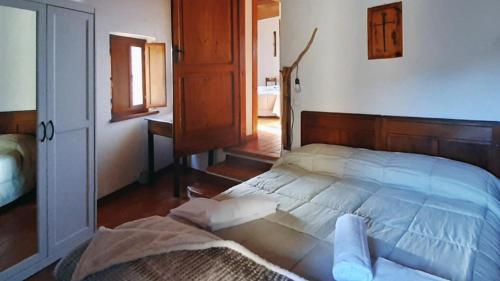 a bedroom with a bed with a wooden head board at Country House Ca' Vernaccia in Urbino