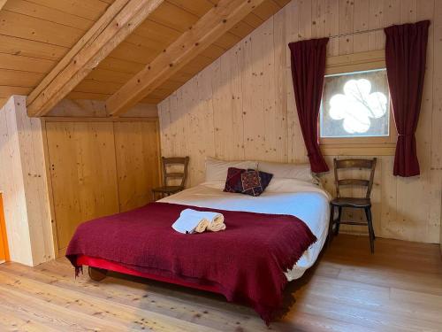 a bedroom with a bed with two teddy bears on it at Chalet Julie in Rocca Pietore