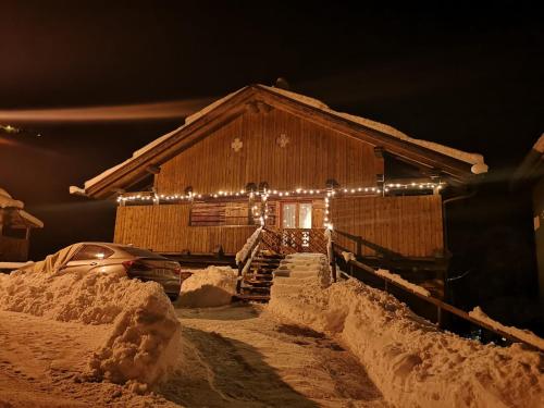 a house with a lot of snow in front of it at Chalet Julie in Rocca Pietore