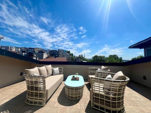 a patio with a couch and chairs on a balcony at Weingart Suites Hotel in Istanbul