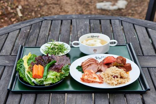a tray with two plates of food on a table at Healience Village in Hongcheon