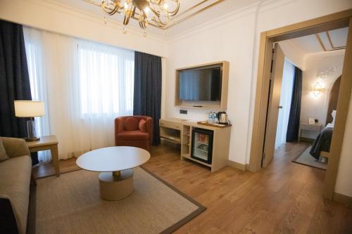 a living room with a couch and a table and a television at La Quinta by Wyndham Giresun in Giresun