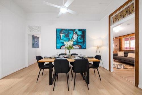 a dining room with a table and chairs at Heritage 5BR home - minutes walk to CBD&South Bank, 3 Parking in Brisbane