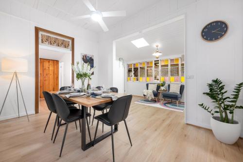 a dining room with a table and chairs at Heritage 5BR Queenslander- Walk to CBD&South Bank, 3 Parking in Brisbane
