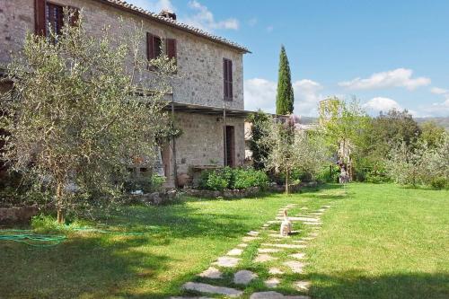 a dog sitting in the yard of a house at One bedroom apartement with garden and wifi at Provincia di Siena in Palazzina