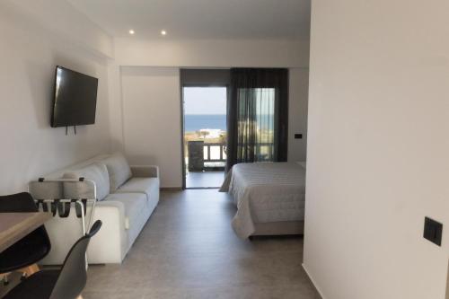 a living room with a couch and a bed at Aegeans Eye in Azolimnos