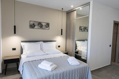 a bedroom with a bed with towels on it at Aegeans Eye in Azolimnos
