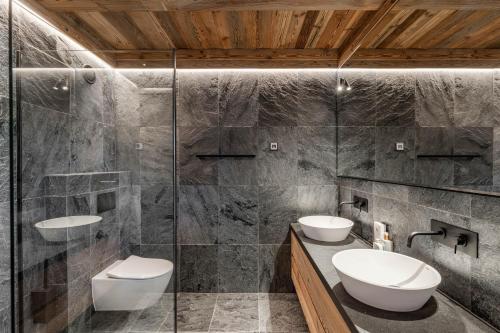 a bathroom with two sinks and a shower at Chalet Getois in Les Gets