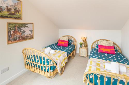 two wicker beds in a small room with at Family Friendly Sleeps 6 in Exmouth By The Sea in Exmouth