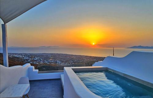 a hot tub on the balcony of a house with a sunset at Martynou View in Pirgos
