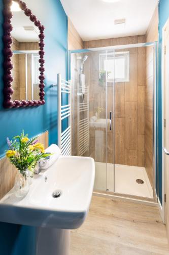 a bathroom with a shower and a white sink at Family Friendly Sleeps 6 in Exmouth By The Sea in Exmouth