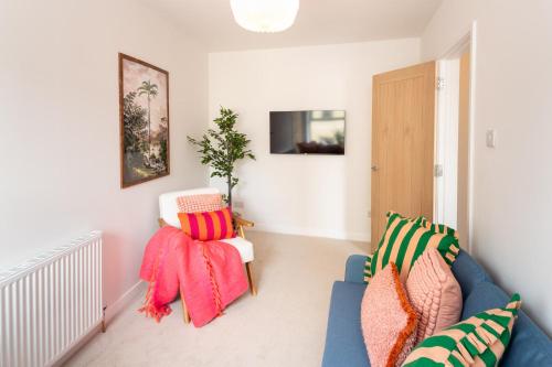 a living room with a blue couch and two chairs at Family Friendly Sleeps 6 in Exmouth By The Sea in Exmouth
