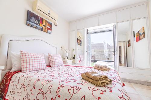 1 dormitorio con 1 cama con colcha roja y blanca en Cozy villa in Madroñal de Fañabe with large private pool, en Adeje