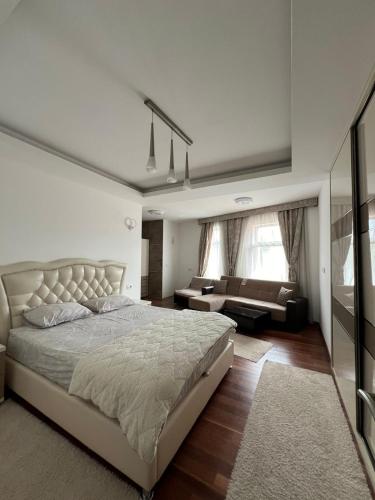 a bedroom with a large bed and a couch at Diamond Hotel & Restaurant Ulcinj in Ulcinj