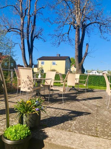 a group of chairs and plants on a patio at Arena Hotell in Vänersborg