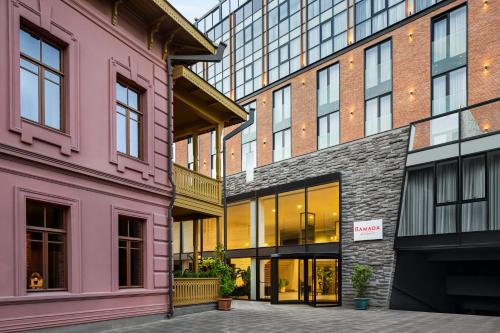 a group of buildings with pink at Ramada by Wyndham Tbilisi Old City in Tbilisi City