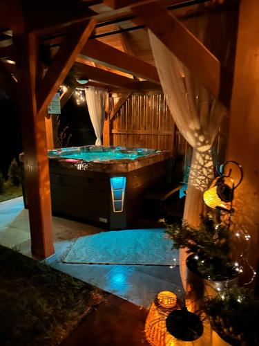 a jacuzzi tub in a backyard at night at Góralska Strefa Domki & SPA in Kościelisko