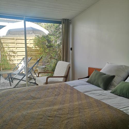 - une chambre avec un lit et une vue sur une terrasse dans l'établissement 100 m de la plage, maison de vacances cœur de St Gilles, à Saint-Gilles-Croix-de-Vie