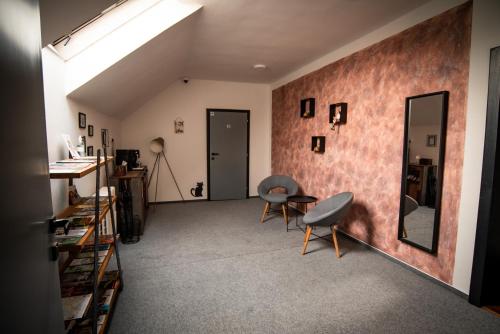 a living room with two chairs and a mirror at APART Mikeš in Telč