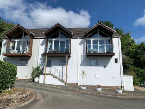a white house with balconies on a street at Alba, Beach Front Close to Restaurant in Lamlash