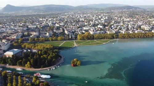 an island in the middle of a large lake at Chambre privée 2 - Chez Vincent - Gare - Centre ville Appartement Partagé -WIFI in Annecy