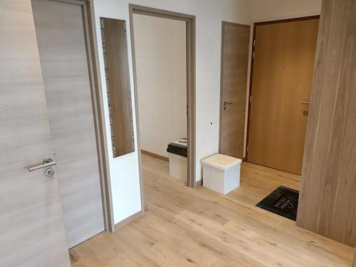 an empty room with two doors and a wooden floor at Chambre privée 2 - Chez Vincent - Gare - Centre ville Appartement Partagé -WIFI in Annecy