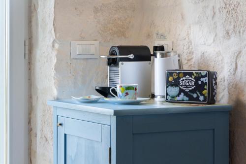 a blue counter with a coffee maker and a cup on it at Trullo Nadia Ostuni in Ostuni