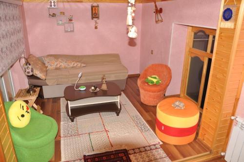 a doll house with a bed and a living room at Загородный дом в горах, Габала in Corat