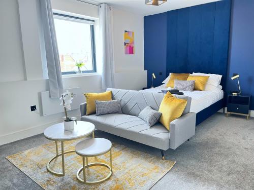 a living room with a couch and a bed at Luxury Norwich City Centre Apartment - Free Parking in Norwich