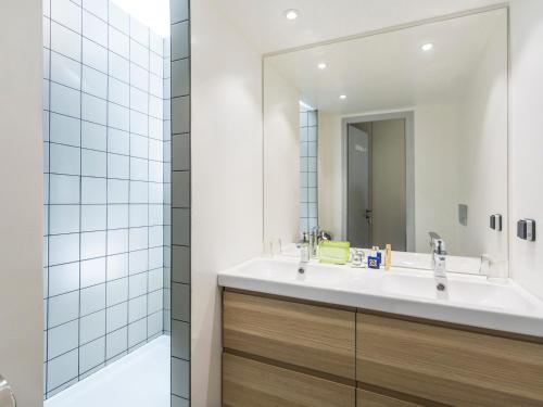 a bathroom with a sink and a mirror at Appartement Les Arcs 1800, 3 pièces, 7 personnes - FR-1-346-331 in Arc 1800