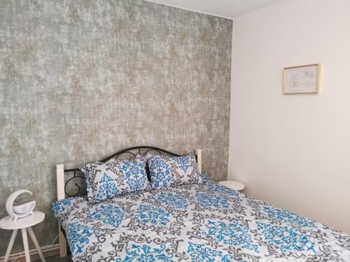 a bedroom with a bed with blue and white sheets at Serene Home in Mediaş