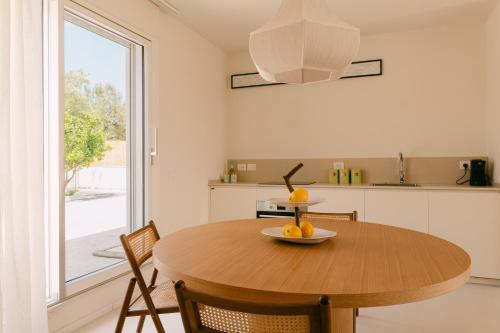 a kitchen with a wooden table with a bowl of fruit on it at CasaCeciliamare in Ortona