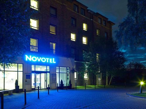 a novation sign in front of a building at night at Novotel York Centre in York