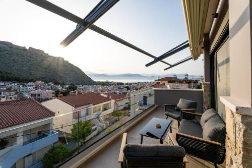 a balcony with furniture and a view of the city at Ennea Muses Rooms and Suites in Nafplio