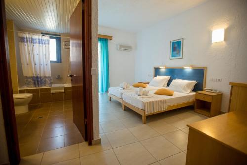 a bedroom with a bed and a bathroom at Neos Ikaros in Agia Galini