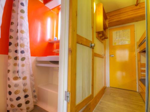 a small room with a closet with a door and a curtain at Studio Les Arcs 1800, 1 pièce, 3 personnes - FR-1-346-473 in Arc 1800