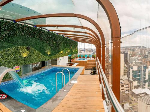 a swimming pool on top of a building at Mercure Alameda Quito in Quito