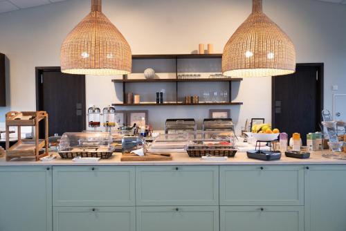 a kitchen with two pendant lights above a counter at Hotel Grimsborgir by Keahotels in Ásborgir