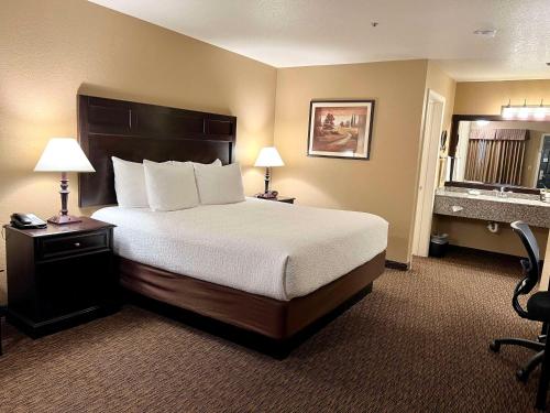 a hotel room with a bed and a desk at Best Western Country Inn in Fortuna