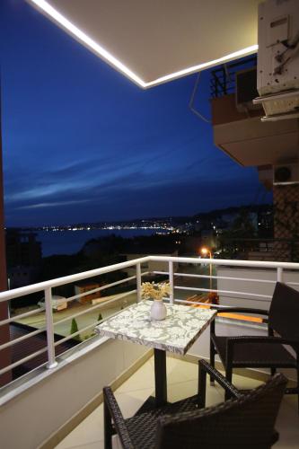 uma varanda com uma mesa e cadeiras num telhado em TekB Rooms & Apartments em Vlorë